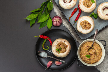 Raw stuffed mushroom caps ready for baking. Fresh champignons, spices, vegetables. Cooking process