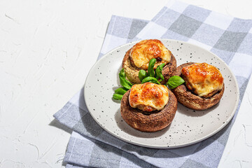 Baked stuffed mushroom caps ready for eating. Champignons, spices, vegetables, cheese