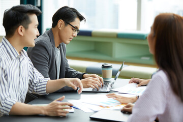 businessman using laptop computer and meeting about work or project with colleague in the office