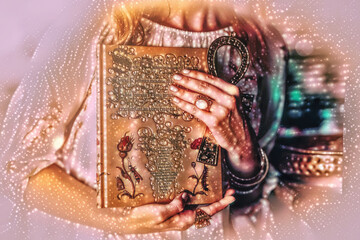 Woman holds ornamental book and Egyptian anch. magic light effect.