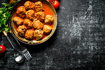 Meat balls with herbs and tomatoes.