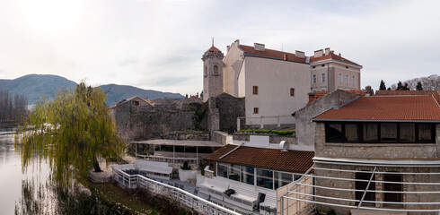 Obraz premium Herzegovina museum in old town of Trebinje with stone fortress wall and tall tower angle view