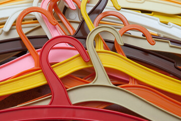 Colorful mess. A pile of colored plastic hangers.