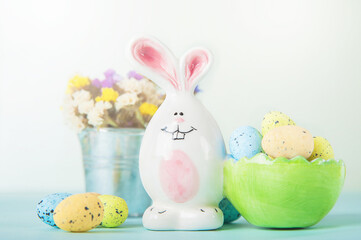 Happy Easter greeting card. Rabbits, colorful eggs, spring flowers with tag for text..