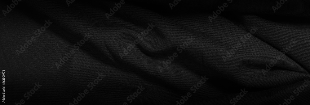 Wall mural dark background from a wavy fabric texture. wide panoramic black background with space for design. w