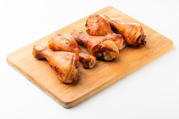 Roasted chicken drumsticks on white background, top view