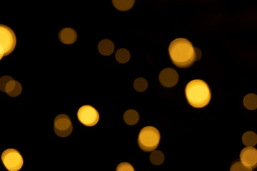Abstract background of blurred yellow lights for design. Lights bokeh dis focus. Festive background, copy space