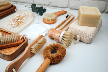 Set of wooden eco friendly devices. Brushes, washcloth and ear sticks, natural soap, textile bags on a white background. Top view