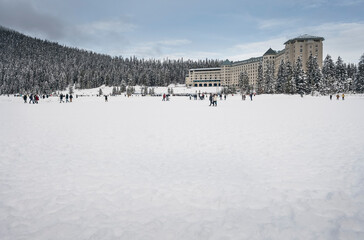 A crowd of unrecognizable people recreate on frozen Lake Louise in Banff National Park, Alberta, Canada