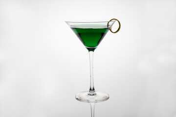 creme de monthe alcholic mint flavored beverage in a cocktail glass isolated on a white background