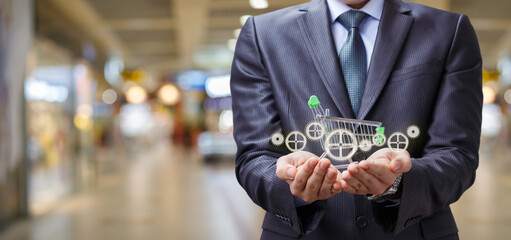Businessman showing shopping cart with control mechanism .