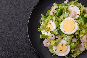 Delicious fresh healthy salad with shrimp, egg, lettuce and flax seeds