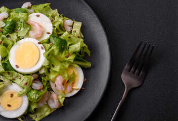 Delicious fresh healthy salad with shrimp, egg, lettuce and flax seeds