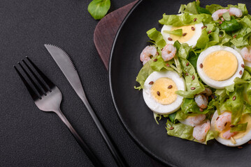 Delicious fresh healthy salad with shrimp, egg, lettuce and flax seeds