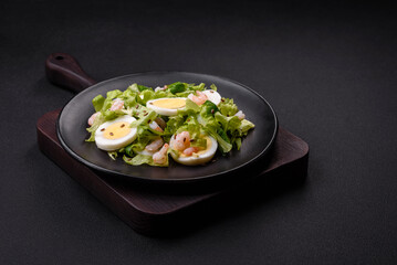 Delicious fresh healthy salad with shrimp, egg, lettuce and flax seeds