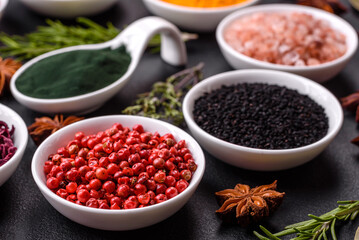 Composition consisting of a variation of several types of spices in white bowls