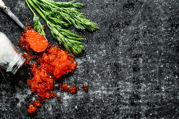 Grains of red caviar with salt and dill.