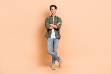 Fototapeta na wymiar Full body length photo cadre of youngster student folded arms looking interested mockup opening new restaurant isolated on beige color background