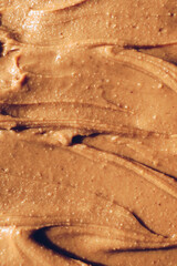 Peanut butter texture background. Creamy smooth brown nut spread.