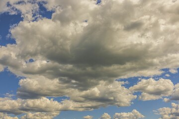 Close-up view of puffy white clouds on blue sky background. Beautiful nature backgrounds concept. 