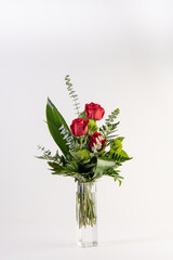 Red roses bouquet in a tall glass vase