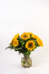 Sun flower bouquet in a glass vase in isolated white  background