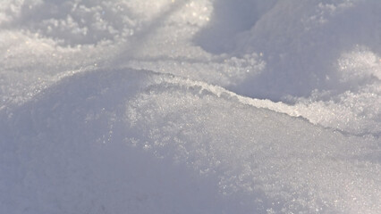 Fototapeta na wymiar Snow surface with light and shadow play