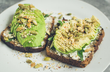 Healthy avocado toasts for breakfast or lunch with rye bread