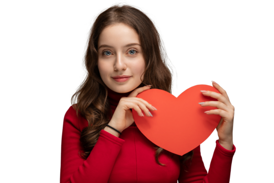 Teenager with a red heart in her hands. Young beautiful girl with long hair.