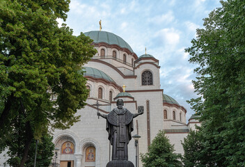 Front view with Statue of Saint Sava and christian catedral with green tree in the capital Belgrade of Serbia - 562519775
