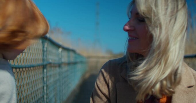 4-year-old son kissing his mummy on the cheek | beautiful nature in the background | 4K, 12 bit video sources: bmd raw