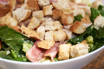 Caesar salad with croutons, lettuce, bacon