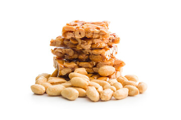 Sweet peanut brittle. Tasty peanuts in caramel isolated on white background.