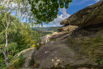 Fototapeta na wymiar rincely Rocks above the Stryi River in the Carpathians, Ukraine - a famous tourist destination. Rock remains above a mountain river with a great view of the mountains, blue sky and valley.