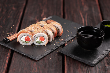 Sushi roll with smoked eel and salmon with cucumber and cheese. Traditional delicious fresh sushi roll set. Sushi menu. Japanese cuisine restaurant. Asian food