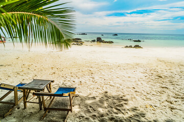 Paradise nature, sea water, tropical beach, sunbeds and palm. Exotic island. Travel destination