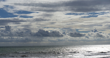 Clouds and ocean on a cloudy day with light relfecting off water