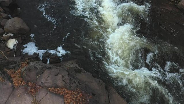 Aerial drone view, filming straight down, over the rapids and the rocks of the river in the city of Brownburgh-Chatham