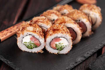 Salmon sushi roll with tuna flakes close-up - sushi asian menu and Japanese food