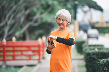 white-haired elderly person exercising in the park early in the morning.