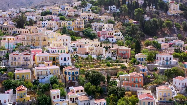 View on Symi (Simi) island harbor port, classical ship yachts, houses on island hills, Aegean Sea bay. Greece islands holidays vacation travel tours from Rhodos island. Symi, Greece,  Dodecanese.