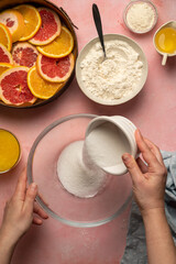Cooking upside down orange cake with fruit juice and ingredients for cooking, baking orange cake, sugar, flour, milk.