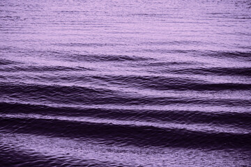 Purplish abstract background of wavy sea surface