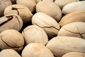 Close up Cracked pecans Nuts on black