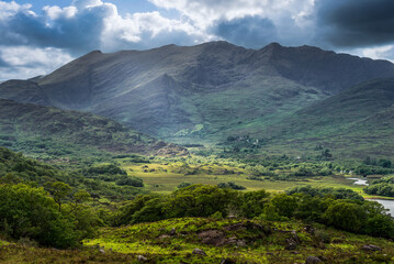 Clouds and green mountains with lakes, amazing nature of Ireland in Killarney National Park, Ring of Kerry, near the town of Killarney, County Kerry