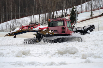 Ski resort and Snowcat. Snow removal from the slope