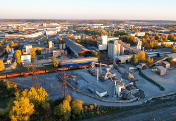 Industrial plant, top view. Cement plant for cement production. Cement Factory in city. Ecology concept and poor environment.