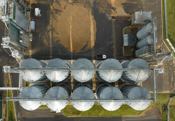 Silo storage at farm. Elevator for storage siliage and grain. Feed Silos Hopper for storage of wheat and barley. Grain drying in agro plant. Silos granary elevator. Processing manufacturing plant.