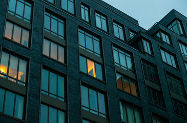 Modern apartment building and luxury real estate in the Lower East Side of New York City. Moody real estate shot at dusk.