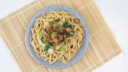 Mie Ayam, Indonesian street food. noodles with chicken ang vegetable served in plate